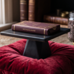a chocolate bar is on a pedestal on a red velvet pillow